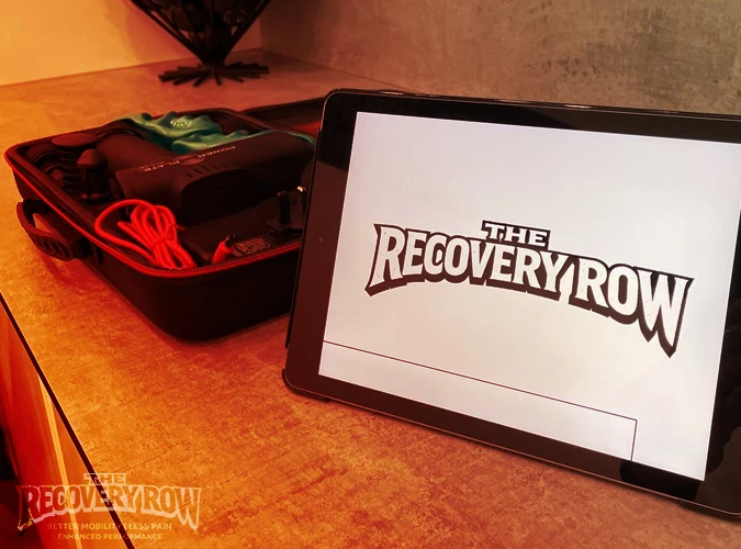 the recovery row company logo on a tablet on a table in the sports therapy room